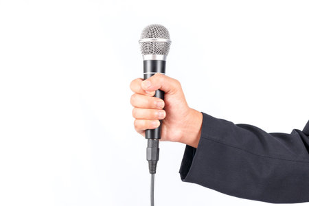 Business man holding a microphone isolated on white background