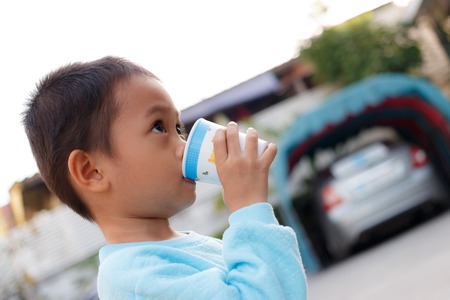 boy enjoys drinkingの写真素材