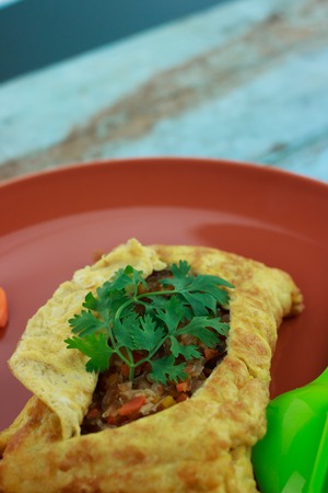 stuffed omelette, Omelet with vegetable salad and Heart-shaped carrot, on blue old woodenの写真素材