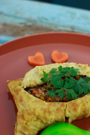 stuffed omelette, Omelet with vegetable salad and Heart-shaped carrot, on blue old woodenの写真素材