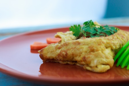 stuffed omelette, Omelet with vegetable salad and Heart-shaped carrot, on blue old woodenの写真素材