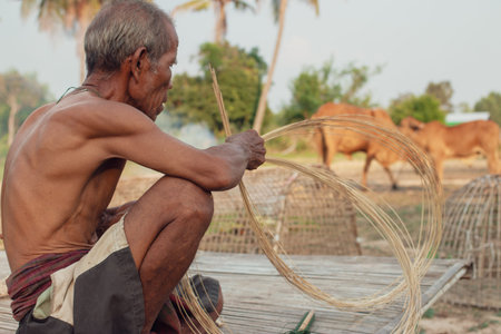 Fisherman with wicker toolsUncle Asian fisherman with wicker tools.の写真素材