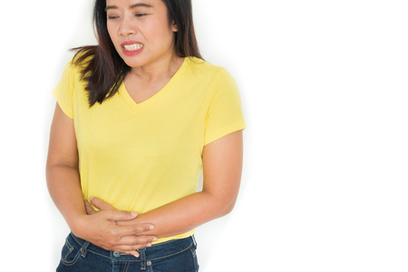 Woman stomach ache health care concept on white background isolationの写真素材