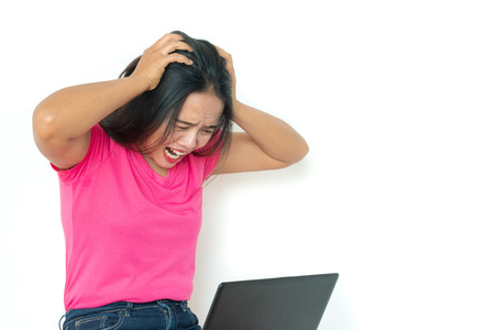 woman using laptop on white background ,Unhappy and angry mood.の写真素材