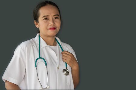 woman doctor with stethoscope isolated on gray backgroundの写真素材