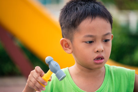 Little boy play toy tool in playground