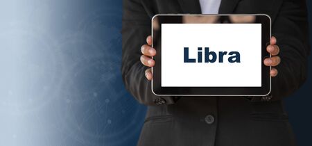 Financial investment concept,Person holding a tablet showing lettersの写真素材