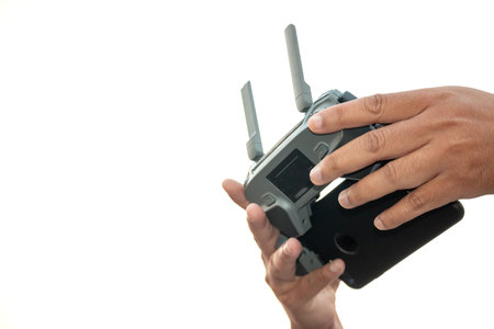hands with remote controller of drone outside.