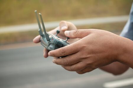hands with remote controller of drone outside.の写真素材