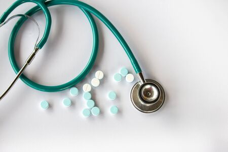 Health care concept, stethoscope and pills on white backgroundの写真素材