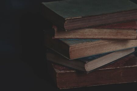 Old vintage books on dark background.の写真素材