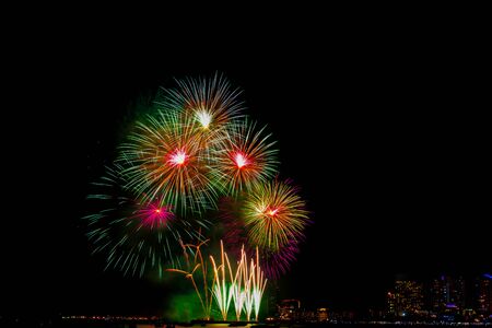 Beautiful colorful fireworks display on the sea beach, Amazing holiday fireworks party or any celebration event in the dark sky.の写真素材
