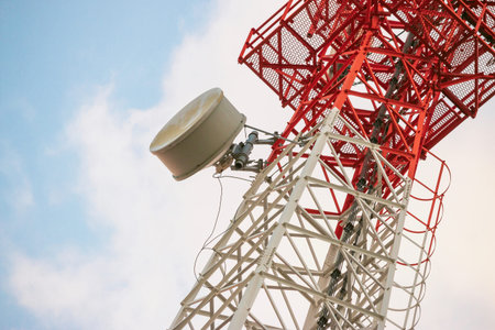 Wireless Communication Antenna Transmitter. Telecommunication tower with antennas on blue sky...