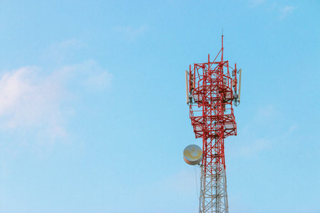 Wireless Communication Antenna Transmitter. Telecommunication tower with antennas on blue sky...
