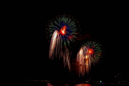 Beautiful colorful fireworks display on the sea beach, Amazing holiday fireworks party or any celebration event in the dark sky.の写真素材