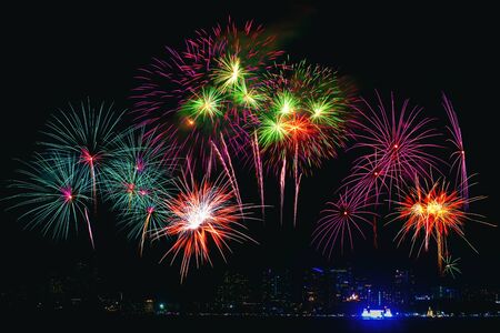 Beautiful colorful fireworks display on the sea beach, Amazing holiday fireworks party or any celebration event in the dark sky.の写真素材