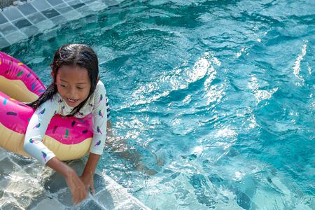 Summer vacation - Cute little girl in swimming pool.の写真素材