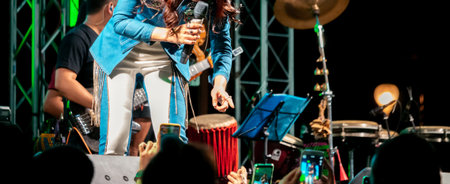 People use mobile phones to live or take pictures at concerts, with bright lights at night.