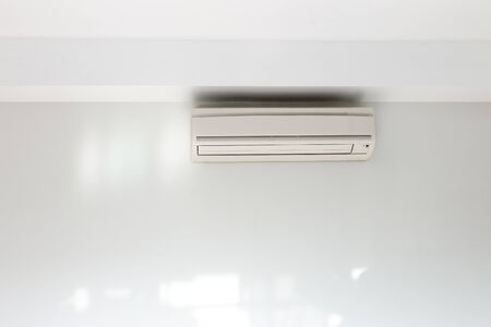Air conditioning Installed on a white concrete wall in the house.の写真素材