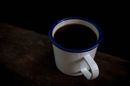 Cup of coffee on old wooden tableの写真素材