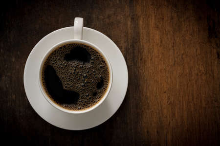 Cup of coffee on wooden background. Copy space. Top view. Flat layの写真素材