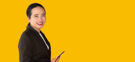 Professional business women holding phones on yellow background