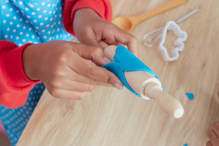Children's hands and simulation cooking toys in the kitchen counterの写真素材