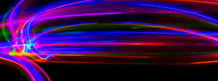 Multi color light painting photography, swirl and curve of blue, green and red light against a black...
