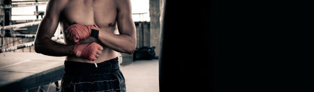 Male boxers wrapped their hands with orange cloth to prepare to fightの写真素材