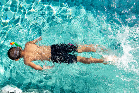 The boy is very happy to swim in the pool. Family vacation conceptの写真素材