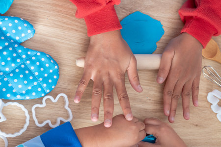 Children's hands and simulation cooking toys in the kitchen counterの写真素材