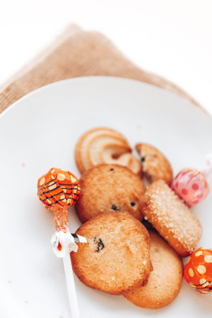 Butter cookies in a white plate on a white background.