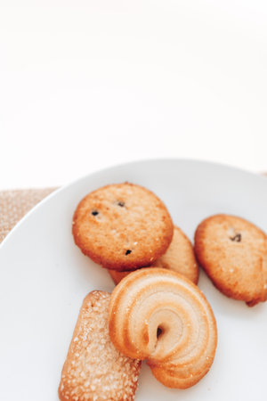 Butter cookies in a white plate on a white background.の写真素材
