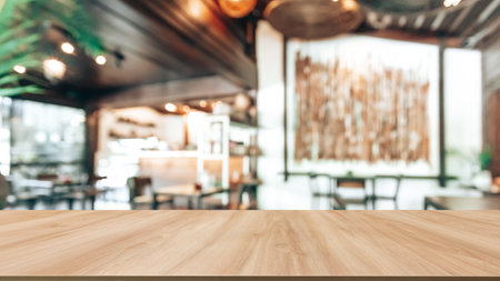 Wooden table top with cafe blurred background.の写真素材