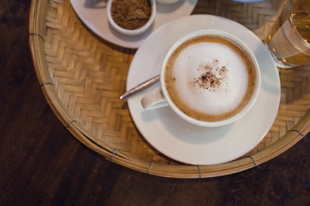Cappuccino coffee served in a Thai style coffee shopの写真素材