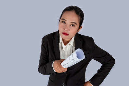 Businessman in the hand have a construction plan or architectural plan, unhappy angry conceptの写真素材