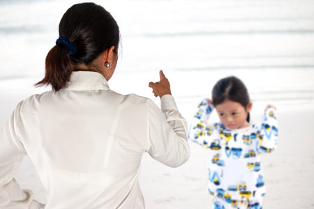 Mother scolds her child because of playing naughty and refusing to obeyの写真素材