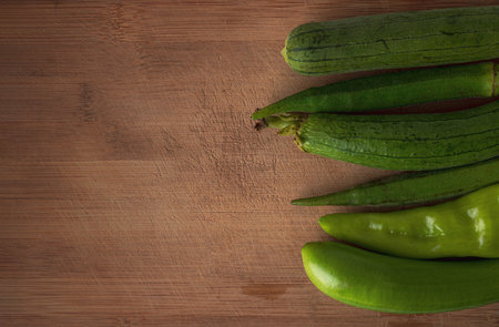 Fresh vegetables ready for cooking shot on rustic wooden tableの写真素材