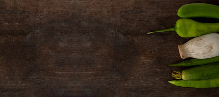 Fresh vegetables ready for cooking shot on rustic wooden table