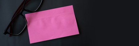 Note paper and glasses on a gray-black background, Reminder paperの写真素材
