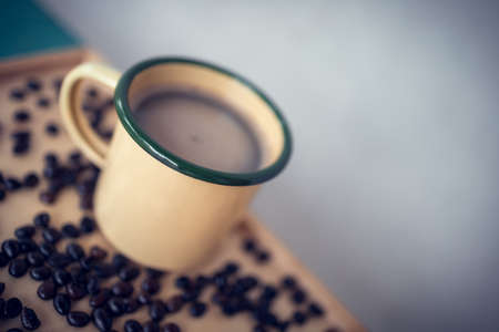 Yellow coffee cup on the desk, refreshing coffee.の写真素材