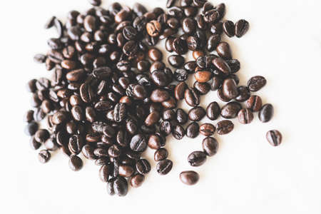 Roasted coffee beans placed on a white cloth.の写真素材
