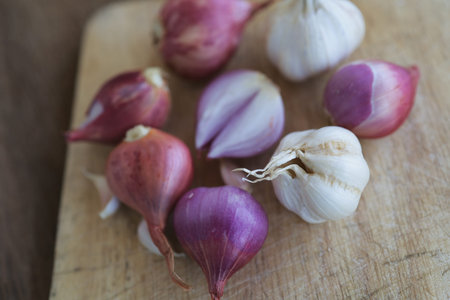 Onion and garlic for cooking on old wooden background