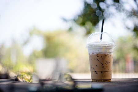 Coffee break, iced coffee on a stone table in the garden.の写真素材