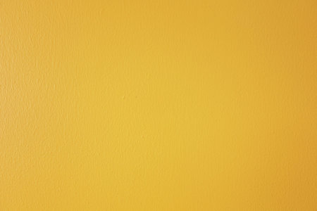 Bright yellow painted concrete wall background imageの写真素材