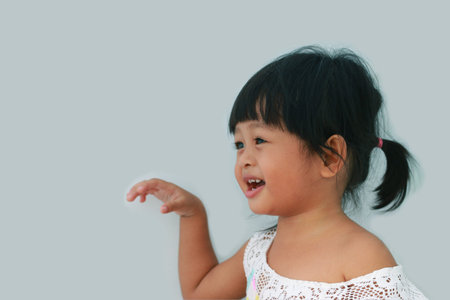 Portrait of a cute Asian girl smiling happilyの写真素材