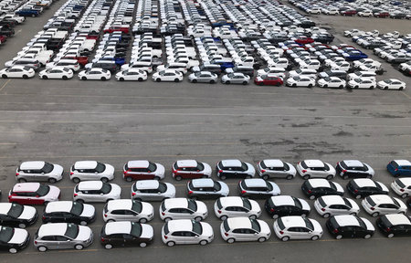Many cars from the factory prepare to be transported at the port.