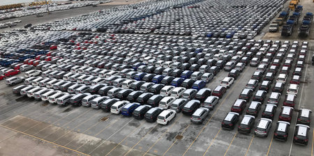 Many cars from the factory prepare to be transported at the port.