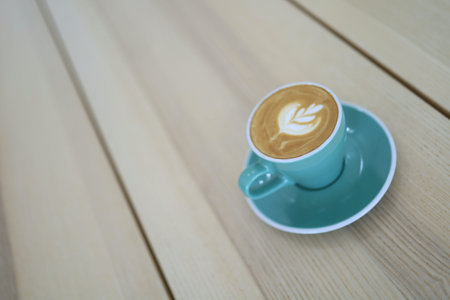 A coffee mug with latte art in a coffee shop.