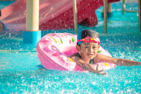Children frolic at the water park. It is a sunny, perfect day for getting wet and playing hard.